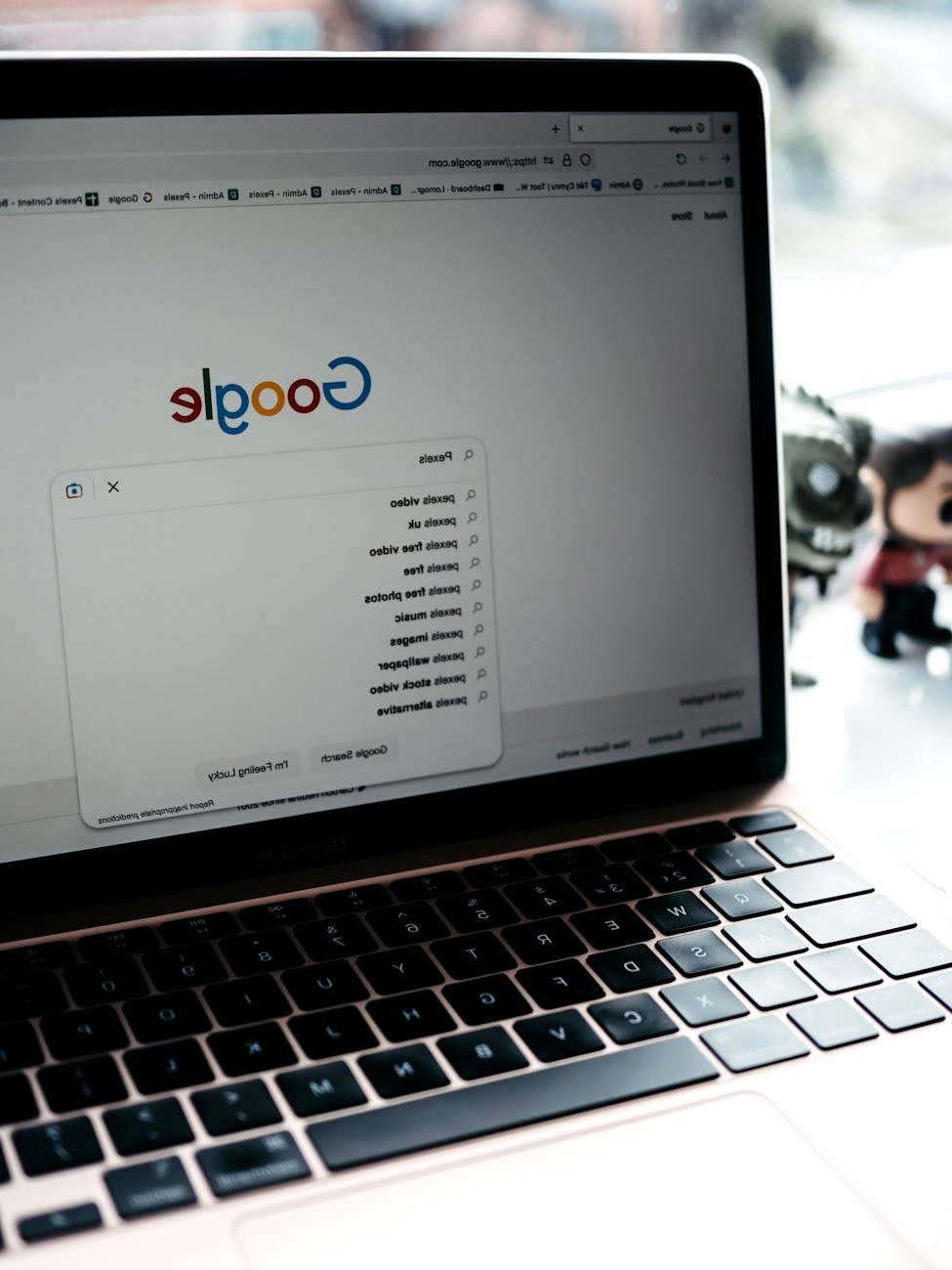 User typing on a laptop with a visible search bar on the screen